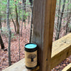 FewwEssentials Dhoop Incense Sticks labeled Joy placed on a wooden railing with a forest background.