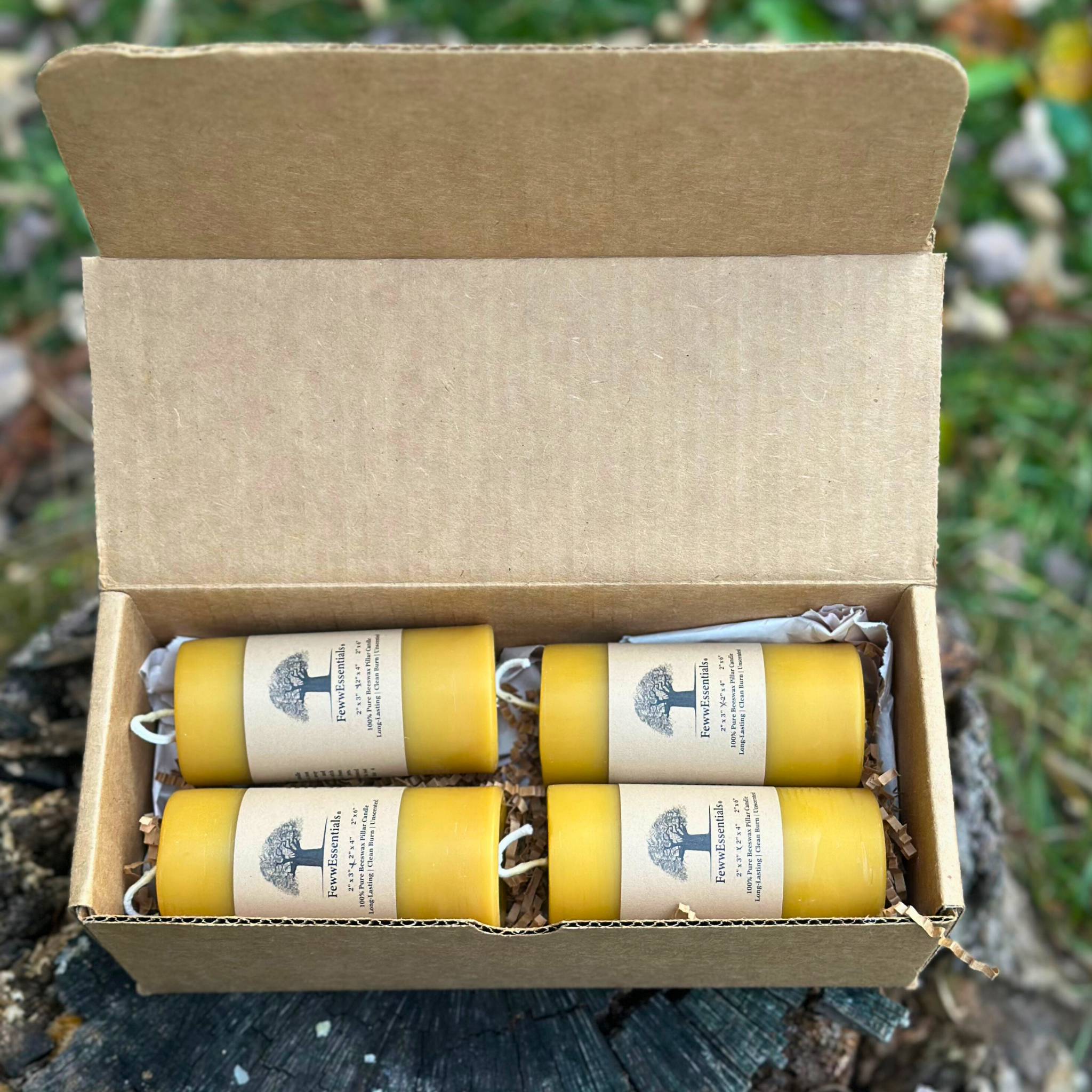 FewwEssentials 2x4 beeswax pillar candle set of four, handmade natural candles in recyclable kraft packaging.