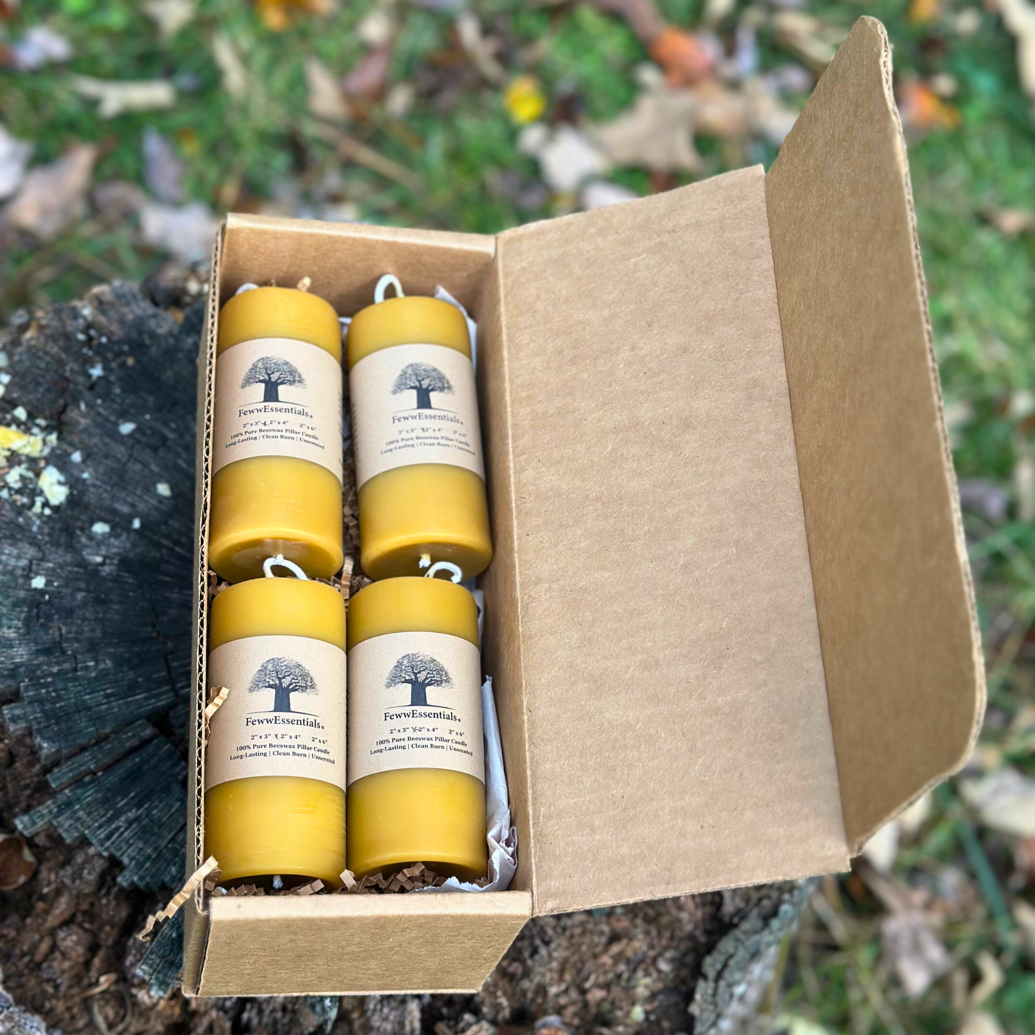 FewwEssentials 2x4 beeswax pillar candle set of four, handmade natural candles in recyclable kraft packaging.